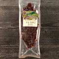 Packaged elk BBQ jerky with a label on a wooden surface
