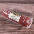 Packaged Elk Cherry Cheddar Salami Chub on a wooden surface.
