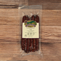 Packaged Elk Cherry Cheddar Snack Stix on a wooden surface