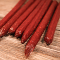 Elk Jalapeno Pepper Snack Stix on a wooden surface
