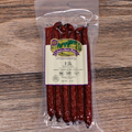 Packaged elk snack sticks with a label on a wooden surface