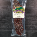 Packaged elk peppered jerky with a label on a wooden background
