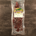 Packaged elk spicy BBQ jerky on a wooden surface