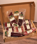 Box of assorted packaged meats on a wooden surface