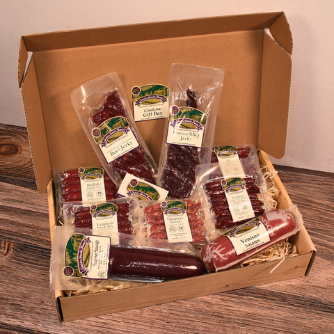 Box of assorted packaged meats on a wooden surface