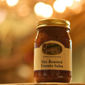 Jar of Fire Roasted Tomato Salsa on a wooden surface
