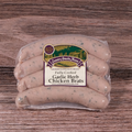 Packaged Garlic & Herb Chicken Brats on a wooden surface