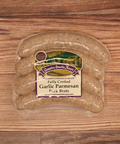 Packaged Garlic Parmesan Pork Brats on a wooden surface