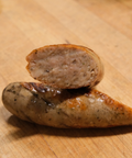 Sliced Garlic Parmesan Brat on a wooden surface