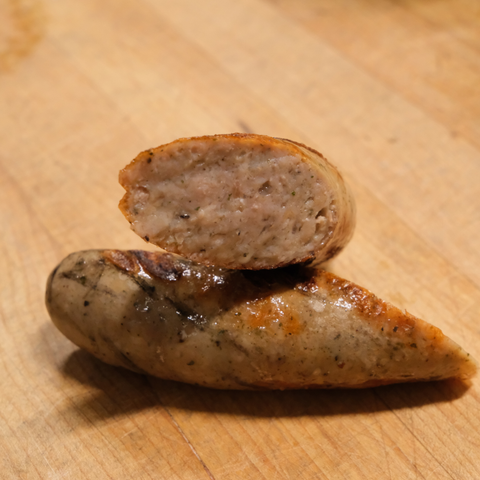 Sliced Garlic Parmesan Brat on a wooden surface