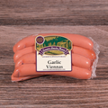 Packaged Garlic Viennas on a wooden background