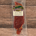 Packaged honey BBQ pork jerky with a label on a wooden surface