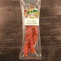 Packaged Honey BBQ Turkey Jerky on a wooden surface