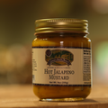 A jar of Hot Jalapeno Mustard on a wooden surface