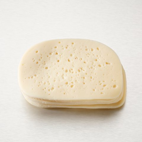 A stack of round, pale yellow cheese slices with small holes, photographed on a clean white background.
