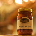 Jar of Mango Lime Salsa on a wooden surface.