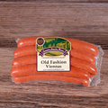 Packaged Old Fashioned Viennas on a wooden surface.
