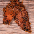 close up of Peppered Turkey Jerky on a wooden surface