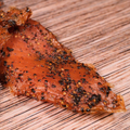 Peppered Turkey Jerky on a wooden surface