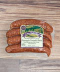 Packaged Pineapple Teriyaki Brats on a wooden surface.