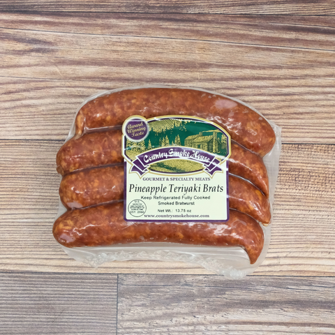 Packaged Pineapple Teriyaki Brats on a wooden surface.
