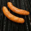 Two Italian Pork Brats on a grill