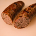 Close up of a sliced Savory German Brats on a cutting board