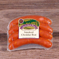 Packaged Smoked Cheddar Brats on a wooden surface.
