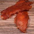 close up of Spicy Honey BBQ Turkey Jerky on a wooden surface