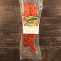 Packaged Spicy Honey BBQ Turkey Jerky on a wooden surface