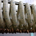 Spinach Feta Chicken Brats on a rack