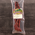 Packaged Steak Cut Beef Jalapeno Jerky with a label on a wooden surface