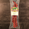 Packaged steak cut beef jerky with a label on a wooden surface