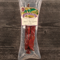 Packaged steak cut beef mesquite jerky with a label on a wooden surface
