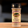 A bottle of Steve's All Purpose Seasoning on a wooden surface.