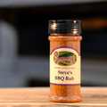 A bottle of Steve's BBQ Rub seasoning on a wooden surface