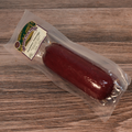 A packaged Summer Sausage on a wooden surface