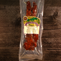 Packaged  Honey BBQ Teriyaki Turkey Jerky with a label on a wooden surface