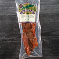Packaged Turkey Cajun Jerky with a label on a dark wooden surface