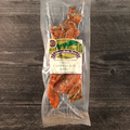 Packaged  Caribbean Jerk Turkey Jerky on a wooden surface with a visible label.