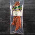 Package of turkey jerky with a label on a dark wooden surface