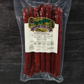 Packaged Uncured Venison Cheddar Cheese Snack Stix on a wooden surface