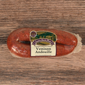 Packaged Venison Andouille on a wooden surface