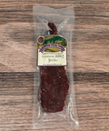 Venison BBQ jerky package on a wooden surface