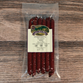 Packaged Venison BBQ Snack Stix on a wooden surface
