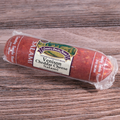 Packaged Venison Cheddar Cheese Salami Chub on a wooden surface.