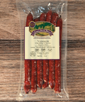 Packaged venison cheddar cheese snack sticks on a wooden surface