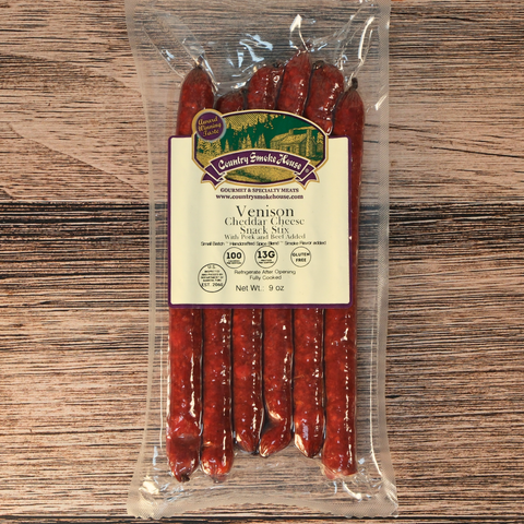 Packaged venison cheddar cheese snack sticks on a wooden surface