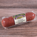 Packaged Venison Cherry Cheddar Salami Chub on a wooden surface.