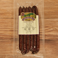Packaged Venison Cherry Snack Stix on a wooden surface